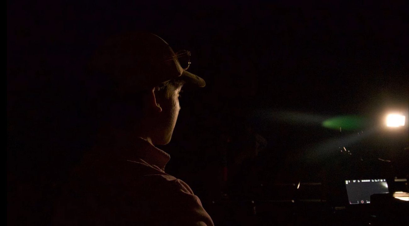 On set, watching a lit scene in the dark