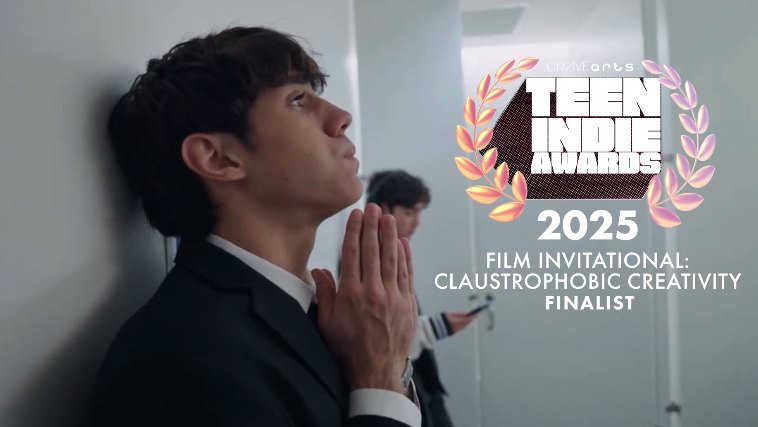 Stalling still: a nervous young man in a blazer praying against a bathroom wall